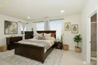 Primary suite with large bath ensuite, walk in closet. (some items digitally staged)