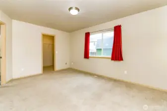 Primary bedroom with walk-in closet and 5-piece bathroom with large garden soaking tub.