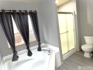 Primary bedroom's bathroom with large garden tub & separate  shower.