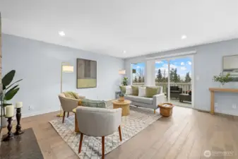 Light-filled living room with large picture window, territorial views, and warm natural light