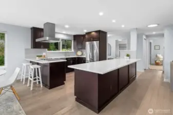 Updated kitchen with oversized quartz island, stainless steel appliances, and abundant cabinetry, designed for everyday living and hosting.