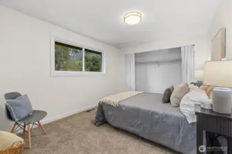 Bedroom with soft natural light, neutral finishes, and comfortable layout ideal for guests, office use, or everyday living.