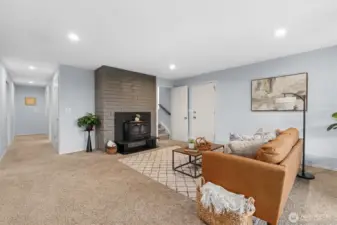 Spacious rec room with fireplace, flexible seating area, and open layout ideal for media, play, or entertaining.