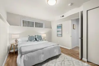 Lower-level bedroom with wood-look floor, and comfortable layout for guests or multigenerational living.