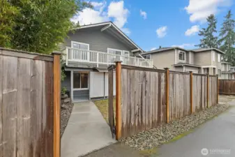 Gated entry and fenced yard access, highlighting privacy and functional outdoor flow around the home.