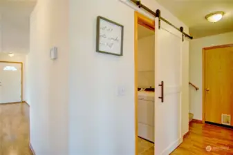 This lovely barn door leads to the utility and powder room