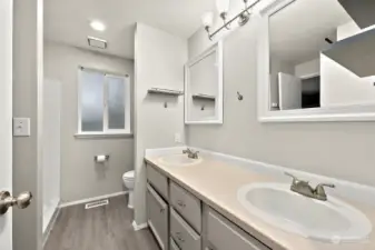 Private Primary bathroom with walk-in shower and dual sinks.