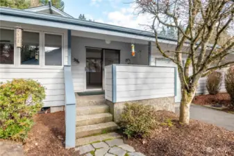 This covered side porch, off the kitchen area, is a great spot for coffee or a glass of wine!