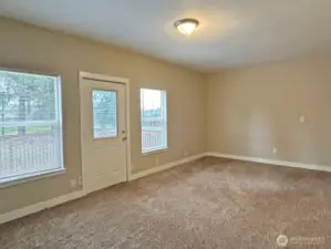 Main floor bedroom with door to the back deck