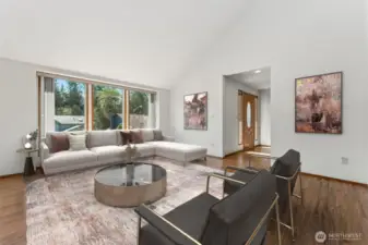 Virtually staged. A row of windows fill the living room with natural light.