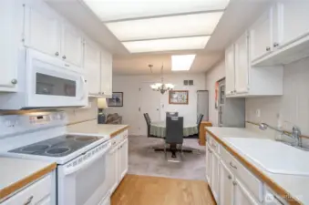 Efficient galley kitchen into dining area.