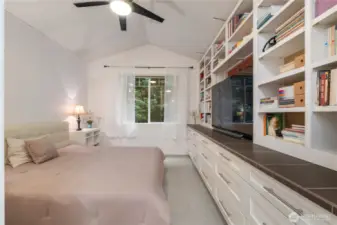 Dawning a spacious vaulted ceiling, Window  Framed in Custom Trim & Mill Work, Custom Built in Shelving & Dresser with a Tile Counter top, & Smooth Opening Drawers. This Master Suite is strikingly sophisticated.