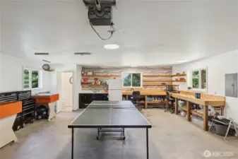 Garage with fridge, sink, counters and half bathroom