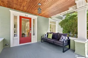 Covered front porch with original bead board ceiling and stately pillars.