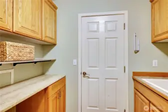 Main Floor Laundry with Washer/Dryer Hook-ups, door leads out to 3 car garage