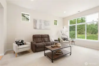 This living room has large picture windows looking out to a beautiful greenbelt.
