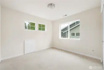 Upstairs bedroom boasts tons of natural light. *Attic access door for additional storage if desired.