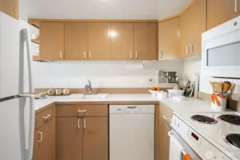 The solid wood cabinets are accented with white appliances and the condition is very nice.