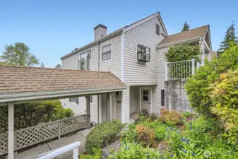 Beautiful landscaping welcomes you and your guests to the entryway of your new home.