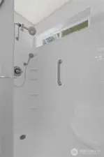 Unwind in the spacious shower featuring a sleek, new shower head for a refreshing experience