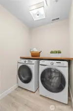 Laundry area accented with a stylish barn door