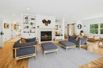 The remodeled main living area centers around a statement fireplace with custom built-ins, creating a polished yet welcoming gathering space. Open sightlines and abundant natural light connect the rooms seamlessly, ideal for entertaining, relaxing, and enjoying the tranquil views of the surrounding acreage.