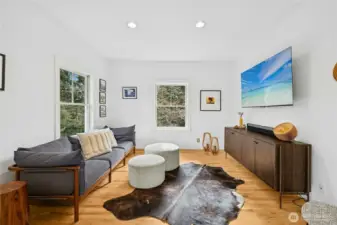 Just off the kitchen and dining area, this versatile bonus room offers a bright, comfortable retreat with clean modern finishes and peaceful wooded views. Ideal as a media lounge, office, or den, it provides flexible space to unwind while staying connected to the heart of the home.