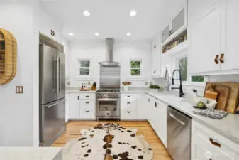 The kitchen pairs crisp custom cabinetry with quartz-style counters, upgraded lighting, and a premium stainless appliance suite. Thoughtful layout and abundant storage make everyday living effortless. Whether you’re hosting, meal prepping, or coming in from the barn for a quick reset.