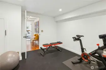 A dedicated home gym on the finished lower level provides a clean, flexible space for workouts, yoga, or training equipment. Tucked away from the main living areas, it’s an ideal wellness zone to support an active, outdoors-forward lifestyle.