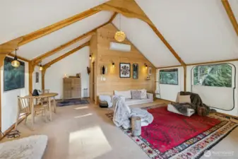 Inside the “Eagle Nest,” the largest of the three safari-style retreats, soaring canvas ceilings and warm wood detailing create a spacious, lounge-like escape with a relaxed Northwest vibe. Thoughtfully appointed with its own heat and flexible living space, it’s an unforgettable setting for guests, creative getaways, or a private retreat on the property.