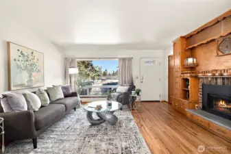 The living room features has cozy fireplace and large built ins.