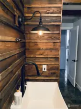 Even the utility sink has been designed with a gorgeous reclaimed wood surround!