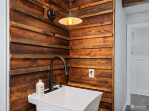 Even the utility sink has been designed with a gorgeous reclaimed wood surround!