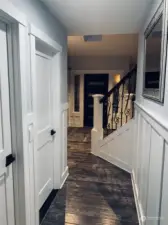 Downstairs hallway with custom built craftmans wainscoting and door casings.