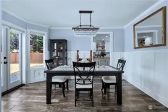 From the living room you flow directly into this large dining room that has been finished with craftsman touches and custom light. French doors open to a new paver patio and create an easy flow from inside to outside living.