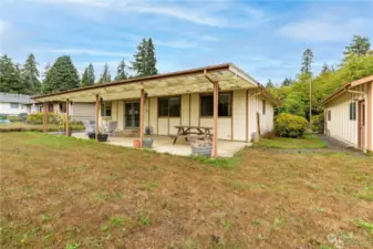 Fruit trees and garden space for you - as you sit on this large backyard patio. Adjacent deep garage building offers a shop space with plenty of possibility.