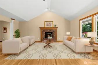 Virtually staged Vaulted great room with a elegant brick fireplace, solid hardwood floors continue from entrance, and follows through to the masterbed area.