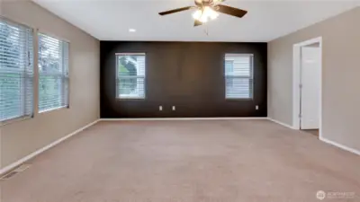 Angle of the primary suite showing door to primary bathroom