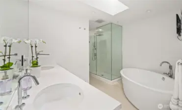 The luxurious primary bathroom features a soaking tub, walk-in shower and heated floors.