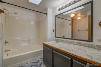 Nice laminate flooring and tub/shower combo.