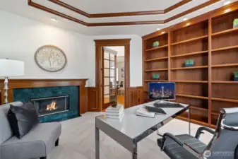 Office with gas fireplace and beautiful built-in book shelves.