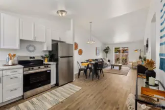 Spacious great room floor plan with new sliding doors leading to private patio and partially fenced yard.