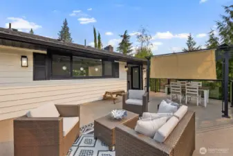 Expansive view deck with waterproof decking, offering both dining and lounging space for effortless indoor-outdoor living. A sleek modern porch light adds a touch of magic in the evenings, making this the perfect spot to enjoy lake views from sunrise to sunset.