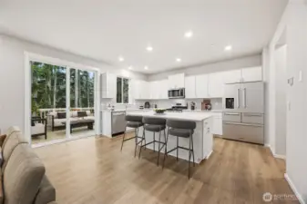 This home will actually have a gourmet kitchen with hooded vent above the range rather than the microwave. Photo's are for representational purposes only. Colors and finishes may differ.