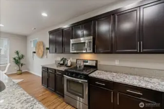 Kitchen features a gas range, ideal for cooking enthusiasts who appreciate precision and performance.