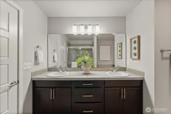 Spacious primary bathroom featuring dual sinks, abundant counter space, and a bright, open layout.
