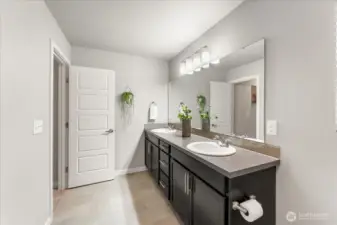 Dual sinks and abundant cabinetry in the Primary Suite.