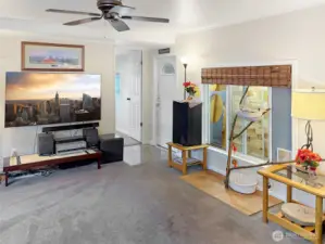 Front Living Room with Ceiling Fan. Door leads to primary en-suite.