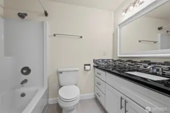 Remodeled bathroom with gorgeous counters and custom backspash