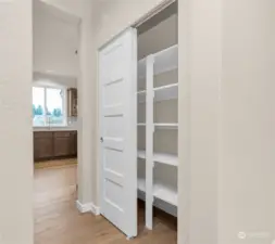 Similar home, not actual. Pantry area with solid shelves.